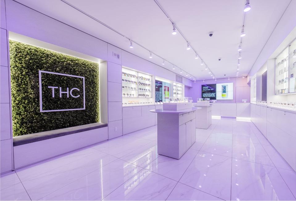 THC Canada from the inside. The store is filled with white marble and display cases.