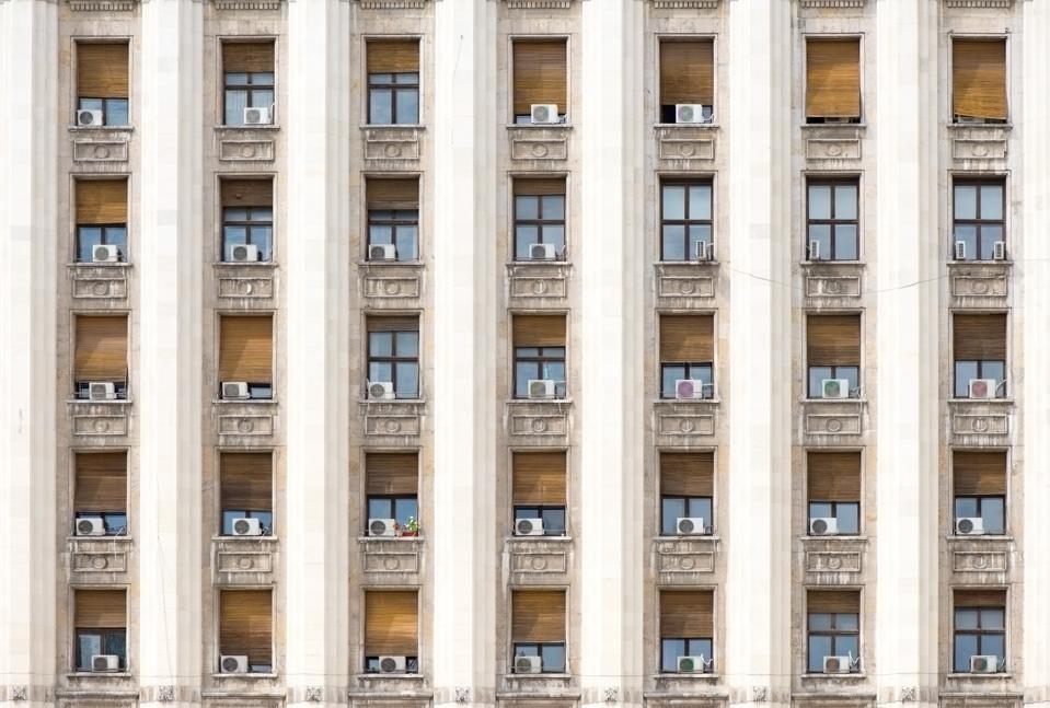 Detail of an old building with windows and air conditioners