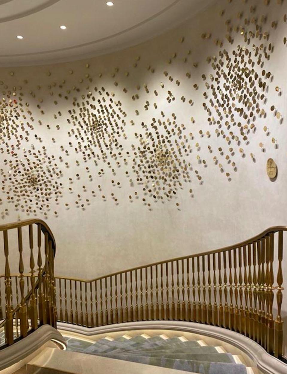 Close up of Starry Night brass sculpture hanging over a staircase.