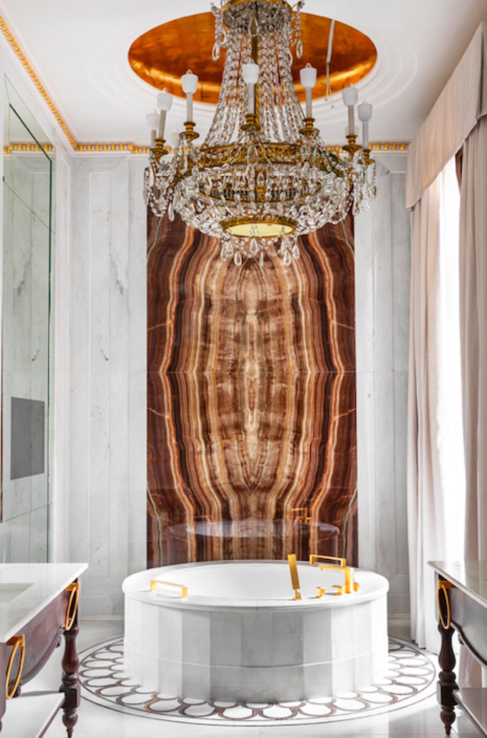 marble bathroom with circular bathtub at Four Seasons Hotel Madrid