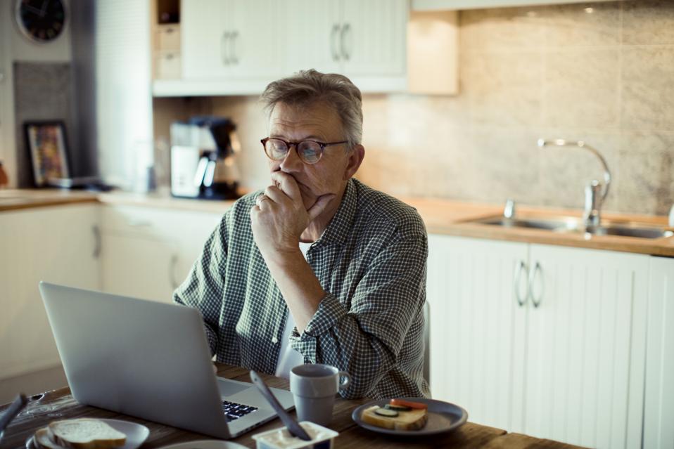 Mature man using a Laptop