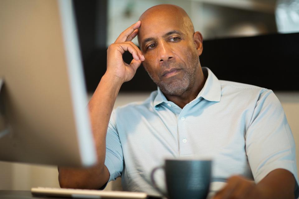 Mature African American man looking frustrated.