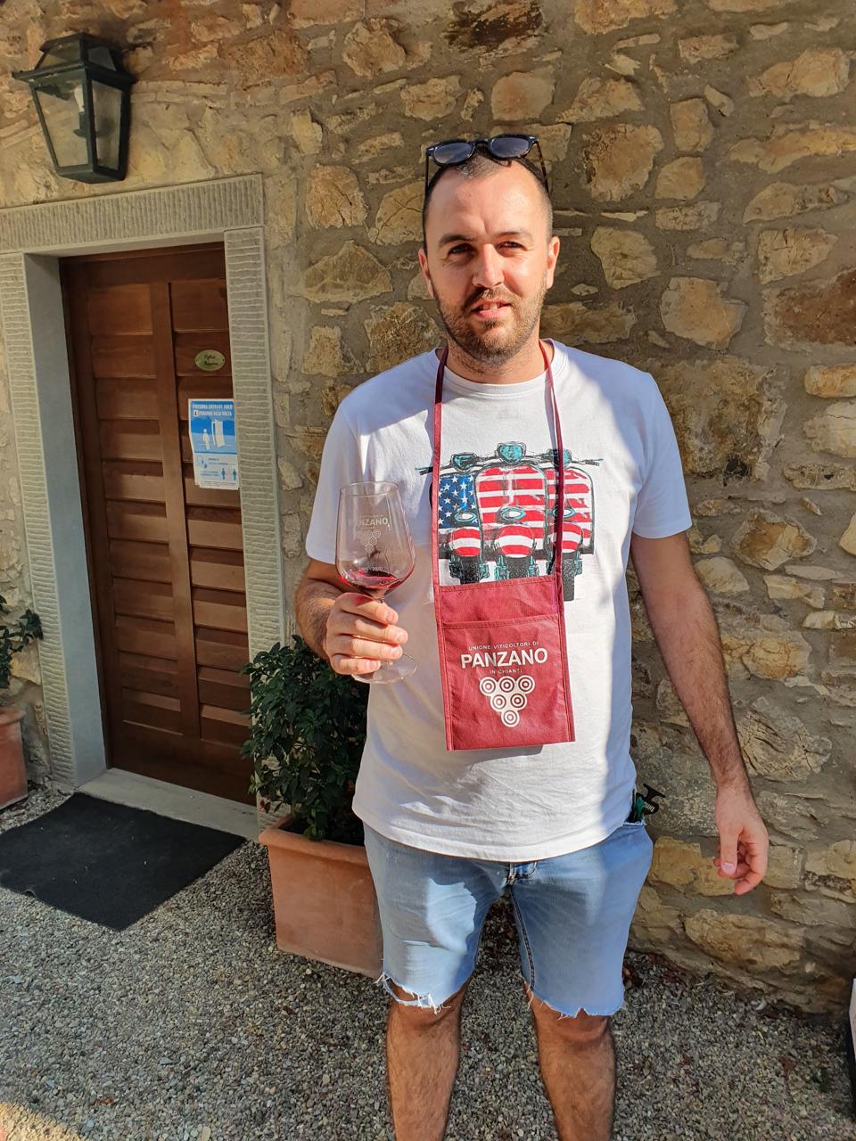 Man with Panzano in Chianti wine glass and holder for tasting festival Italy Renzo Marinai