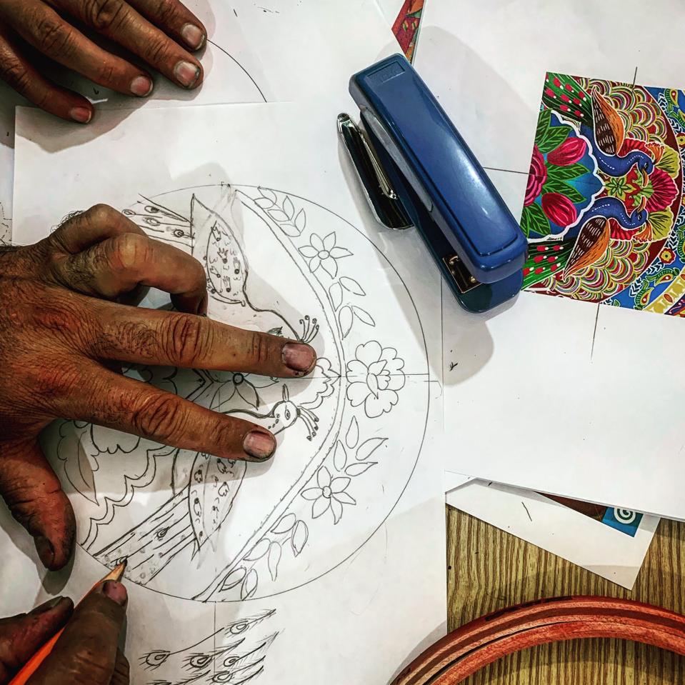 A truck art wall hanging being traced by a Chitrali artist, Farzana, at the Mahraka Centre in Chitral. 