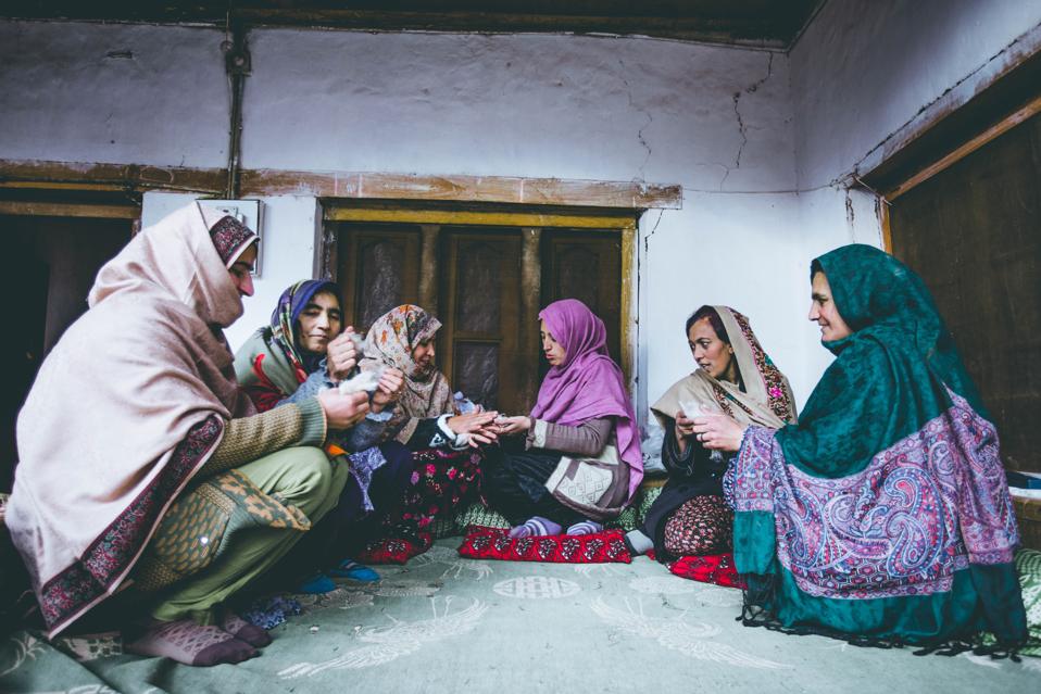 Local women carding wool in Reshun Village, Chitral.