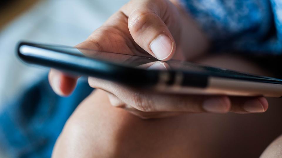 A woman is using a mobile phone