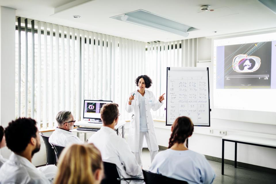 Clinical Doctor Teaching Students At Hospital