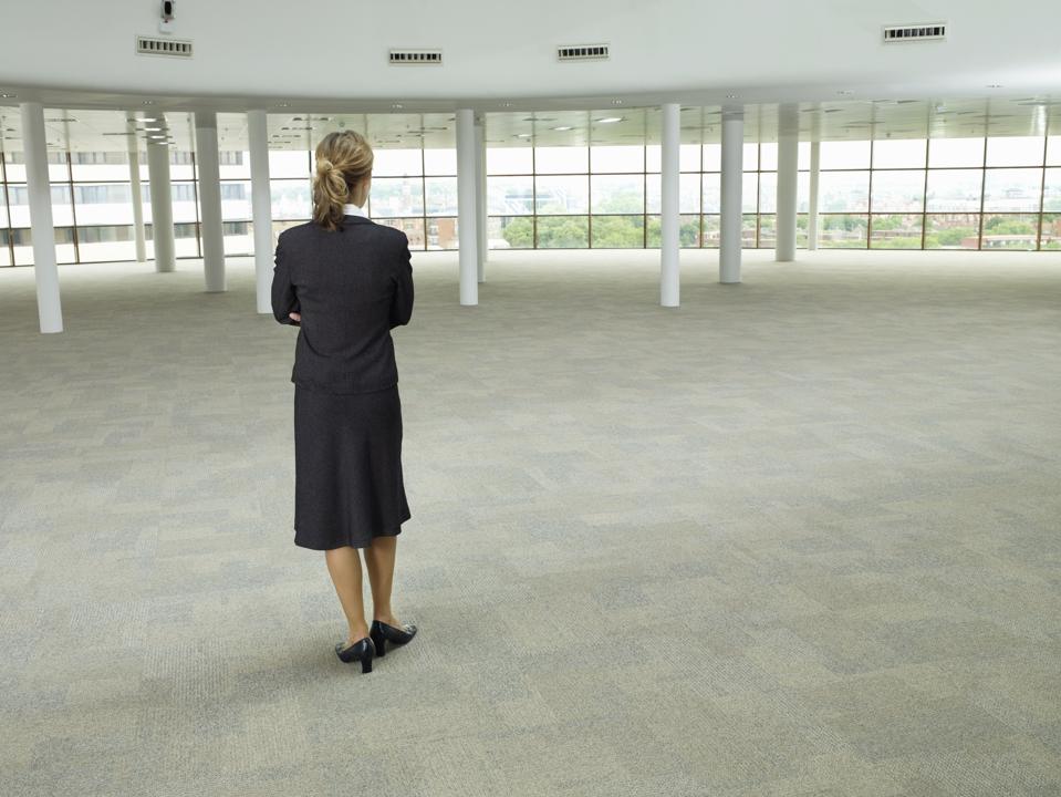 business woman standing in large empty room
