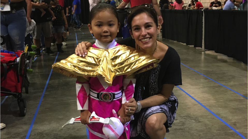Amy Jo Johnson at a convention with a Pink Power Ranger young fan.