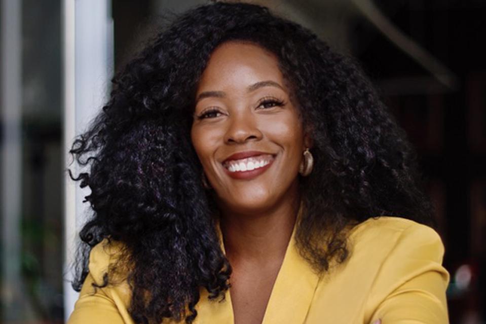 Headshot of Cimone Key, international brand consultant, wearing yellow.