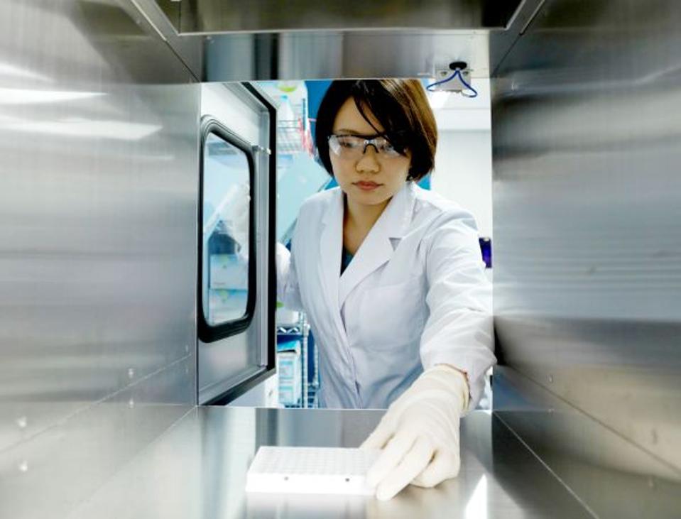 A technician prepares samples at PFDeNA’s lab in Tokyo