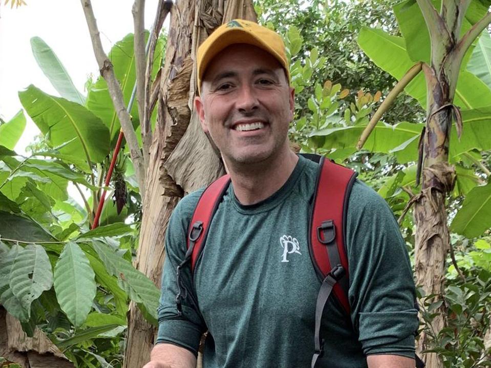 Forbes hiking in a rain forest.