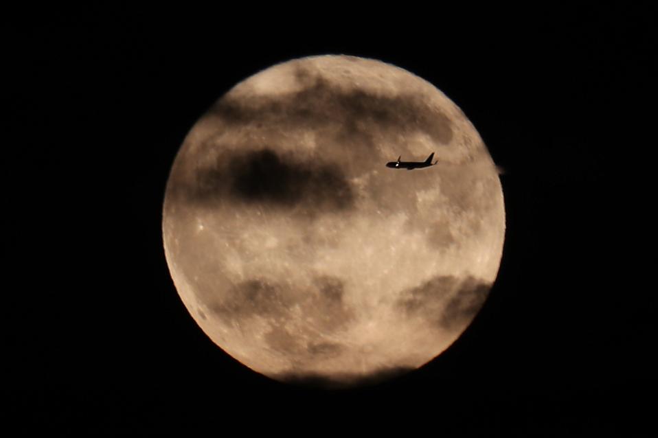 Harvest Moon rises over the Statue of Liberty in NYC