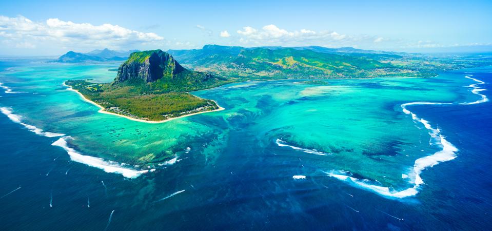Aerial view of Mauritius and famous Le Morne mountain, coral lagoon and 'underwater waterfall' optical illusion