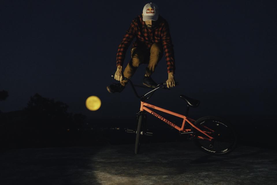 X Games Gold Medalist Terry Adams in the Arkansas Ozarks as the ″Harvest Moon″—the first full moon of fall—rises behind him.