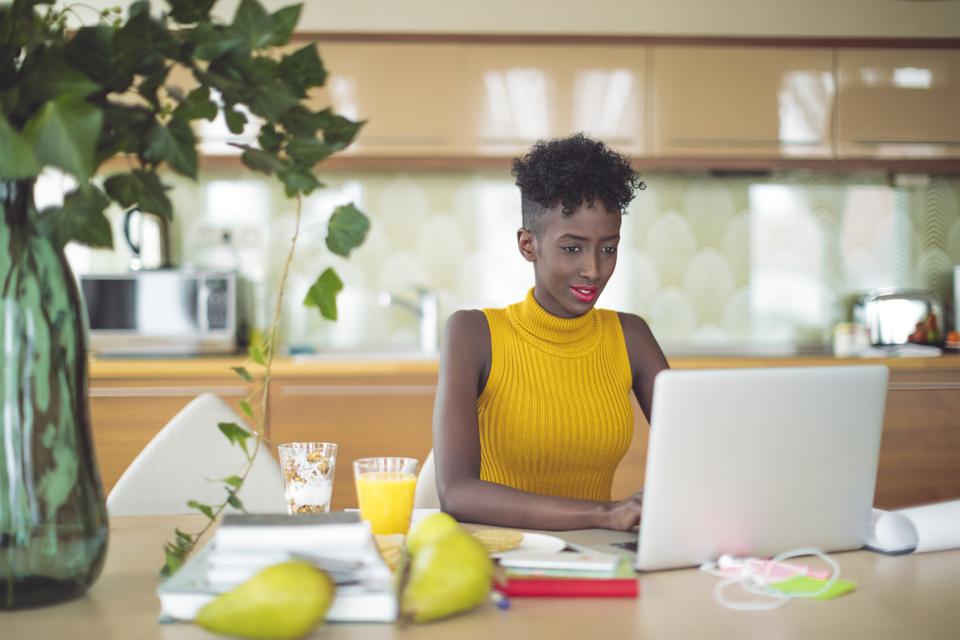 Young woman is working at home on her laptop