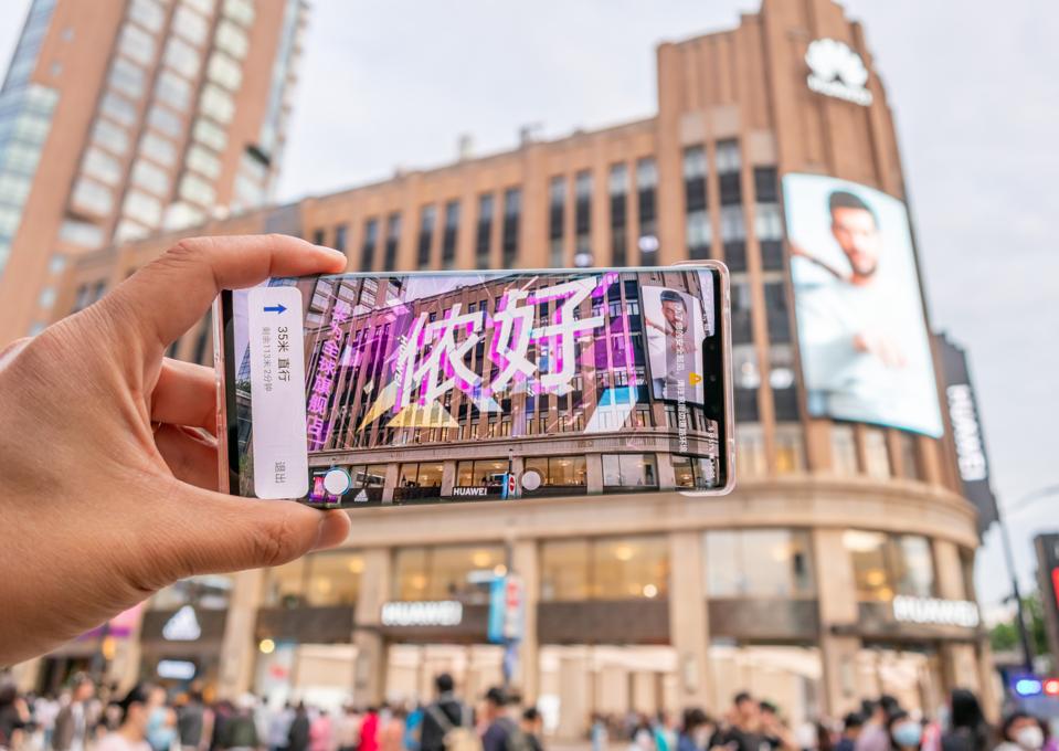 Tourist Visits The Bund With Huawei AR Map In Shanghai