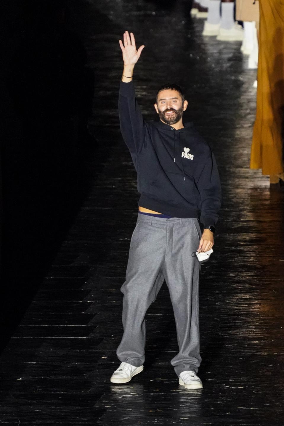 Ami's Alexandre Mattiussi greets guests at the end of his runway collection