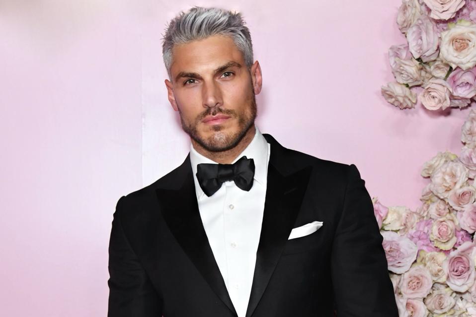 Chris Appleton on a red carpet with roses