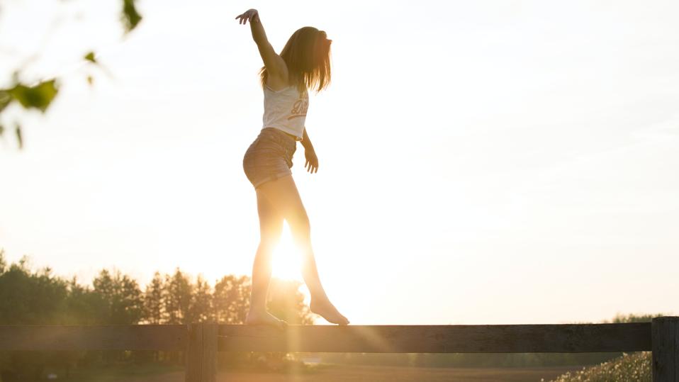 woman balancing on a log