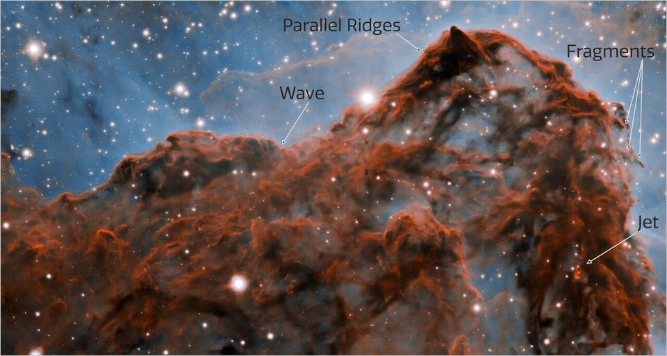 A 50-trillion-km (33-trillion-mile, or 5 light-year) long section of the western wall in the Carina Nebula, as observed with adaptive optics on the Gemini South telescope.