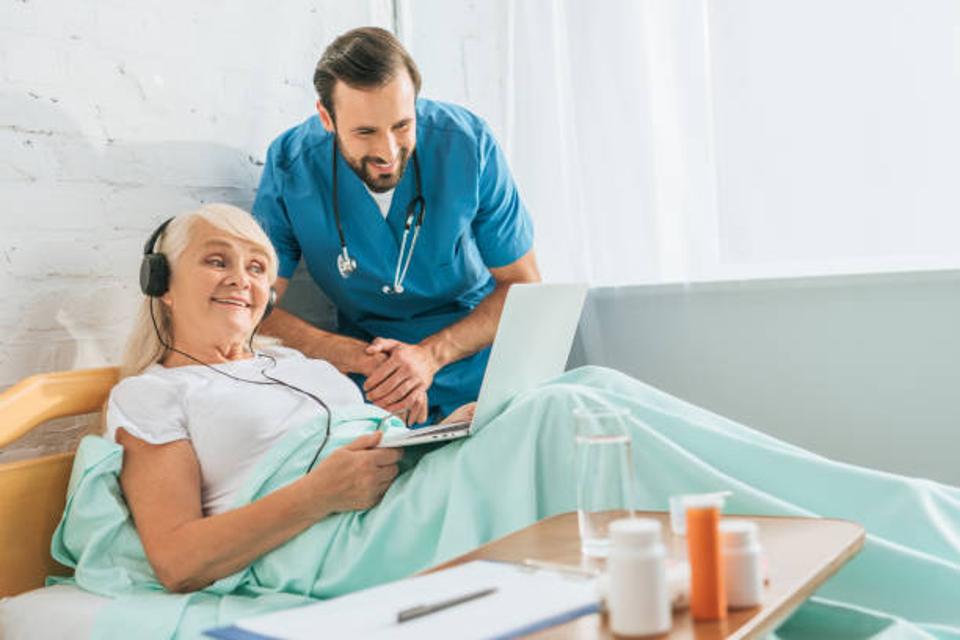 Doctor comforting patient with music.