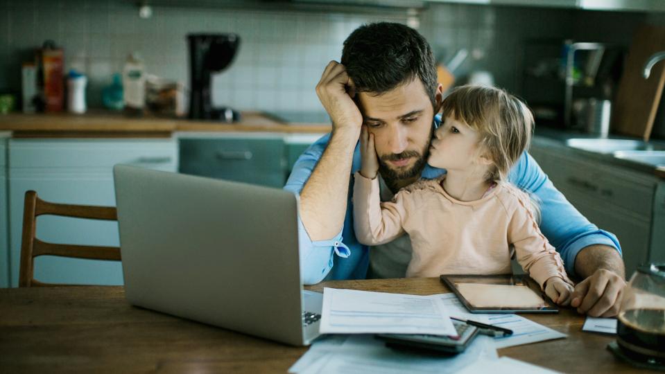 Father and daughter sitting in the kitchen