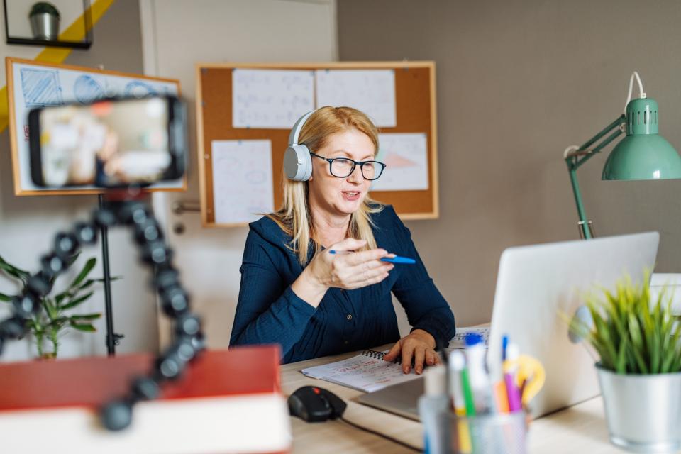 Professor working from home and using internet for online class with students