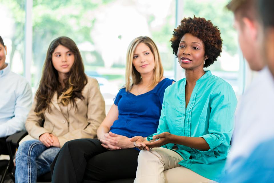 African American woman speaking during group therapy