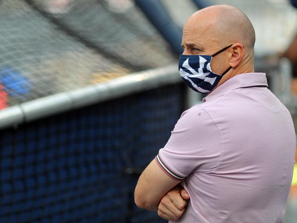 Yankee General Manager Brian Cashman watching batting practice behind the batting cage.