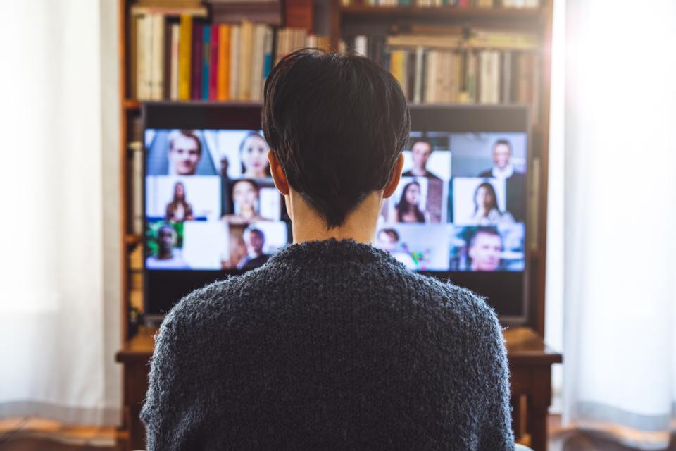 Woman in front of a device screen in video conference for work