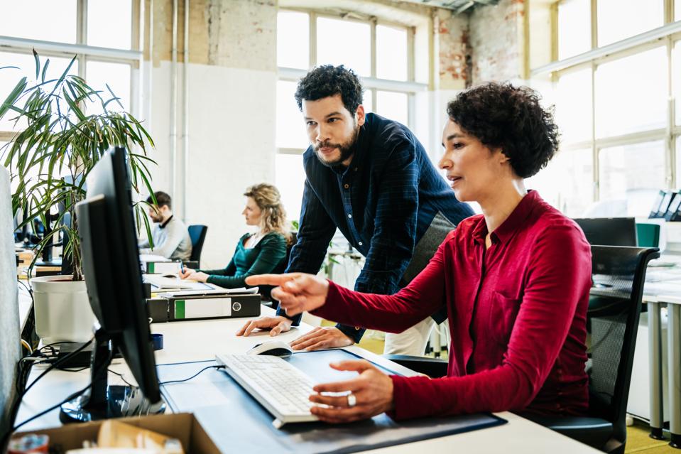 Business Colleagues Looking At Computer Together