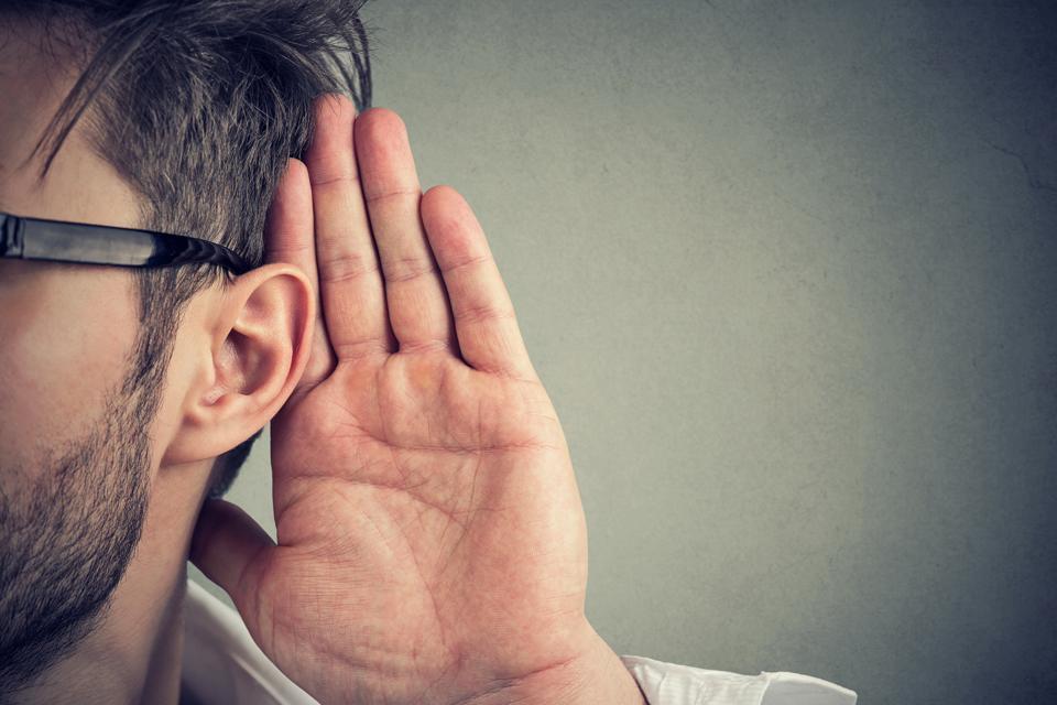 man holds his hand ear