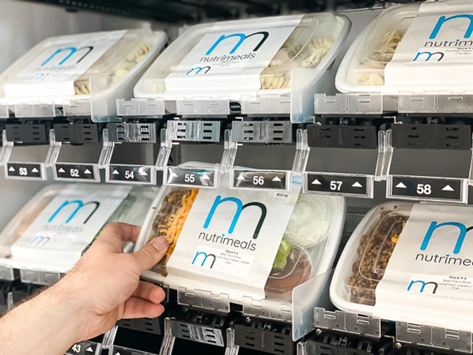 Ready meals being placed in a vending unit.