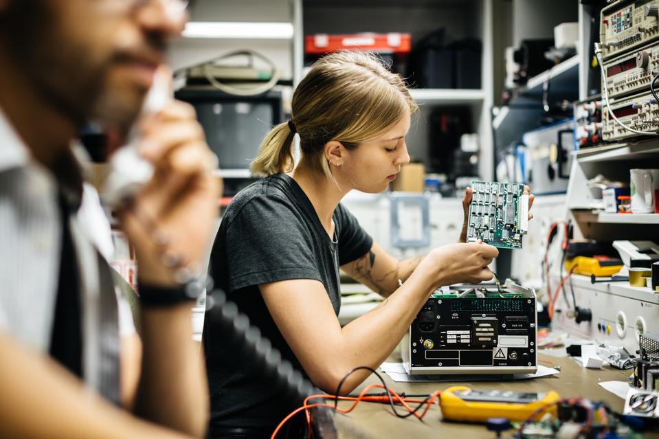 Female Technician Working On Conductor Board
