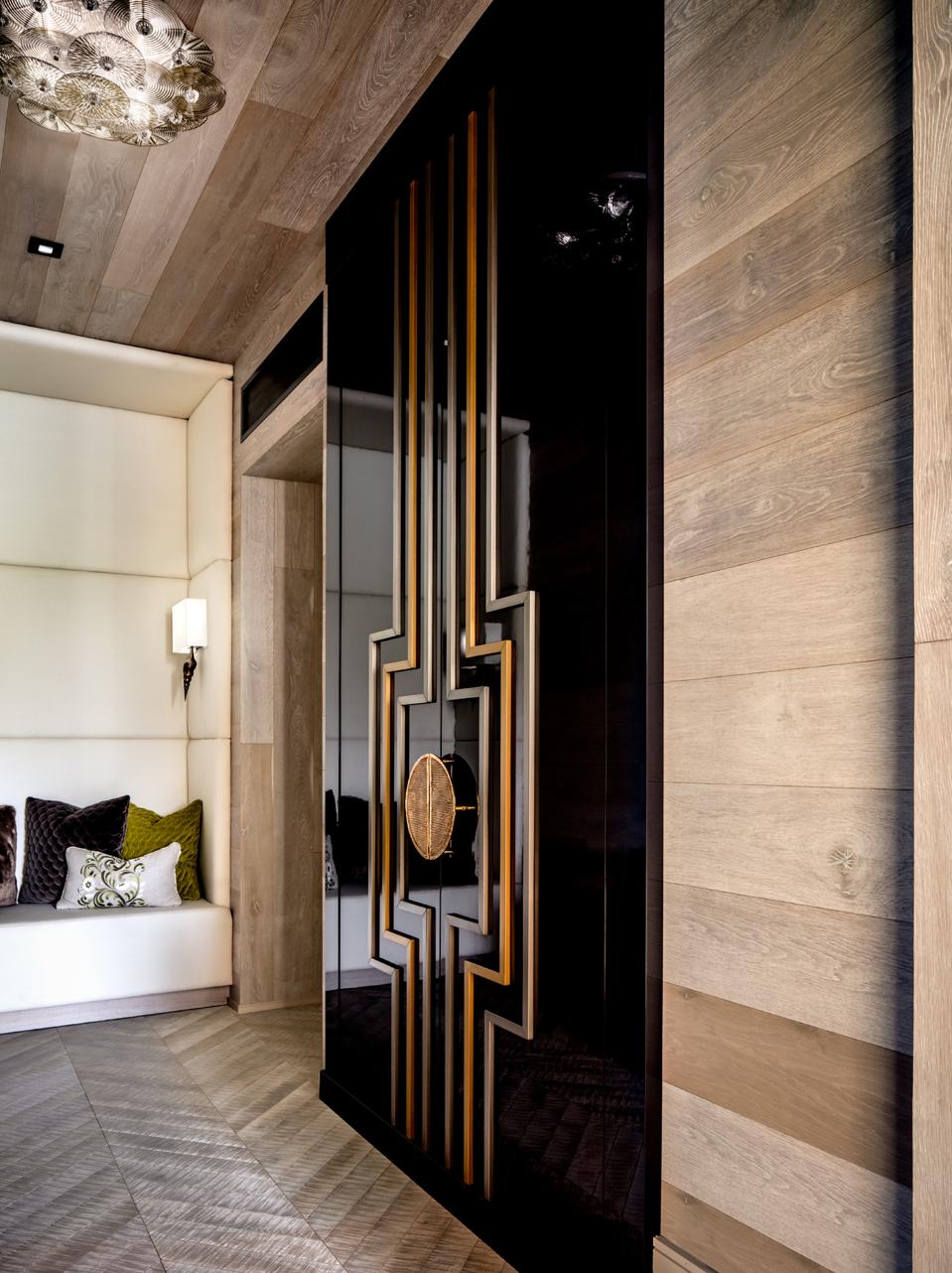 Blonde wood against a black lacquer door.