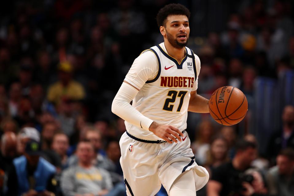 Denver Nuggets guard Jamal Murray dribbles up the court at the Pepsi Center during a 2020 NBA game.