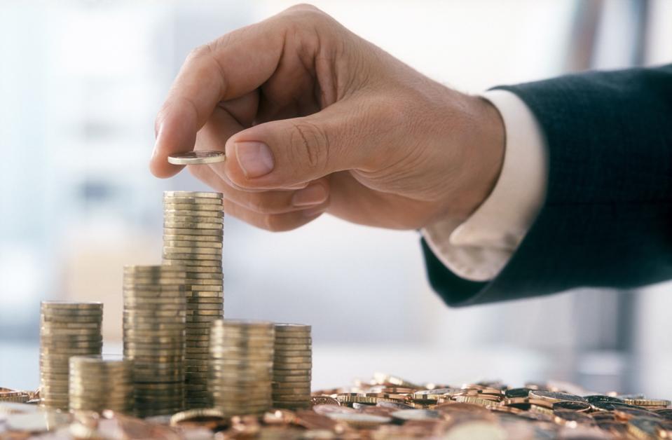 Businessman is stacking coins