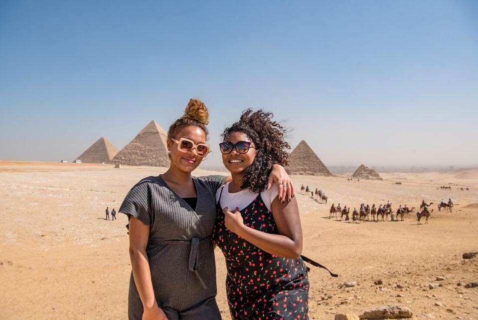 Two travelers visiting the Pyramids of Egypt
