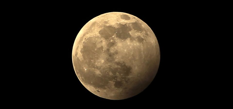 A full moon during a penumbral lunar eclipse.