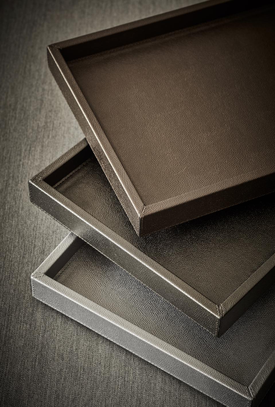 Leather trays handmade in Italy in bronze and silver hues.