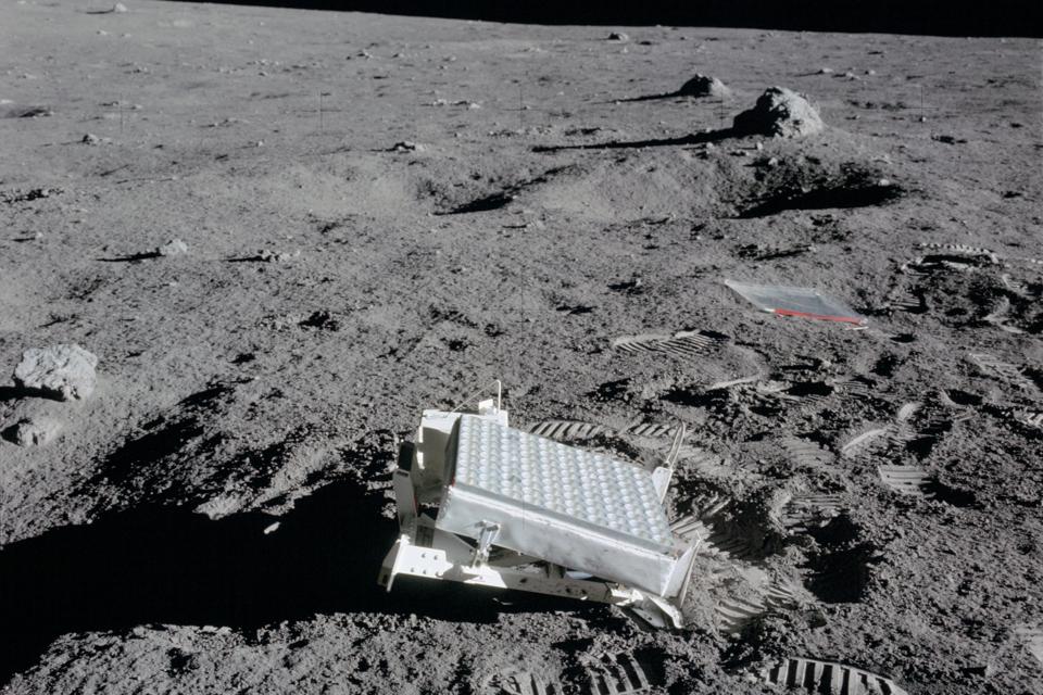 Black and white photo of retroreflector panel on the lunar surface.