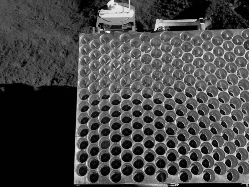 Black and white photo of the surface of a retroreflector panel.