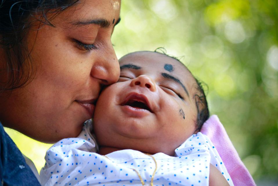 Woman kissing her baby