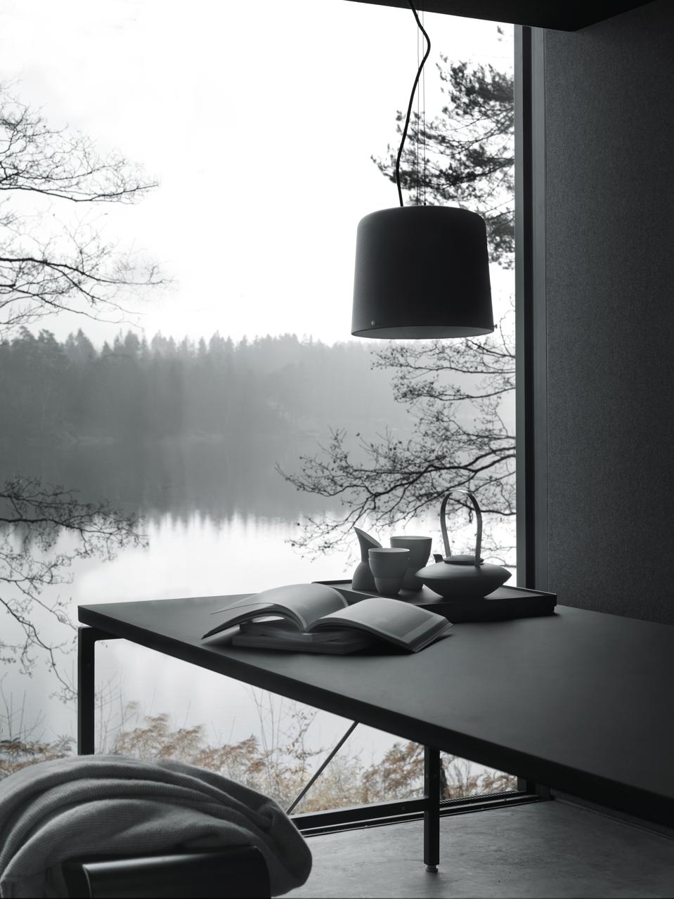 A key nook in the Vipp cabin overlooks a tranquil lake.