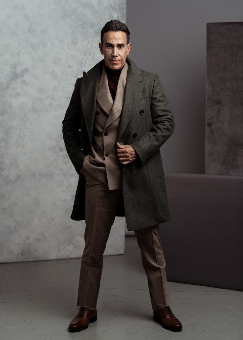 Green Overcoat, Circular Wool Flannel, $599.- https://suitsupply.com/en-us/men/coats/mid-green-overcoat/J778I.html Navy Turtleneck, Pure Merino Wool, $ 119.- https://suitsupply.com/en-us/men/knitwear/navy-turtleneck/SW1040.html Light Brown Havana Suit, Circular Wool Flannel, $598.- https://suitsupply.com/en-us/men/suits/light-brown-havana-suit/C6182I-S.html Brown Oxford, Italian Calf Leather, $249.- https://suitsupply.com/en-us/men/shoes/brown-oxford/FW1106.htmlWardrobe Styling: Jeffrey Ampratwum, Grooming: Stetson Bryan
