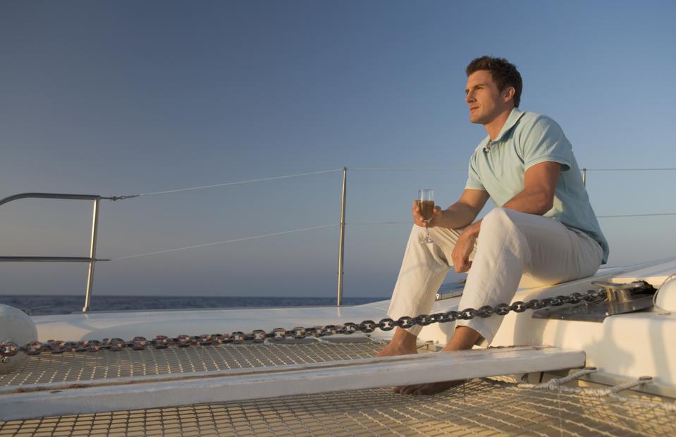 Man relaxing with a drink on a boat