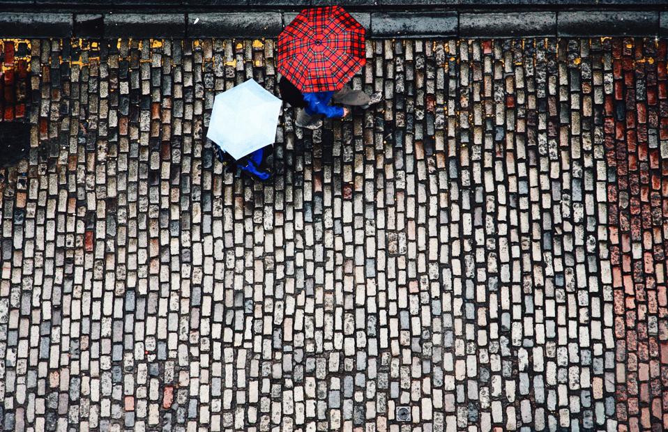 High angle view of cobblestone street and umbrellas