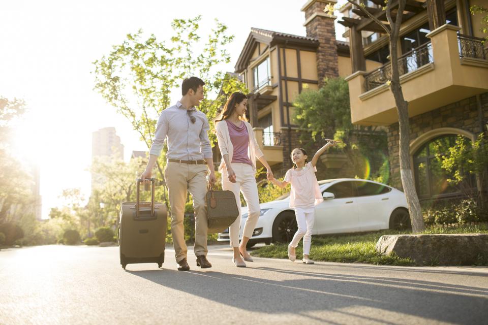 Happy young family going for vacation