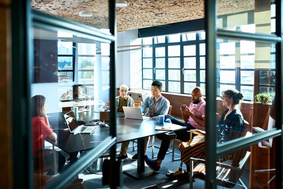 Looking through board room door at business strategy meeting